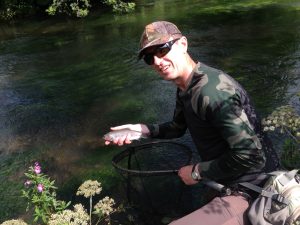 Steve returning a wild rainbow to the Derbyshire Wye.