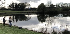 Hooked up to an English common carp while fly fishing a lake.